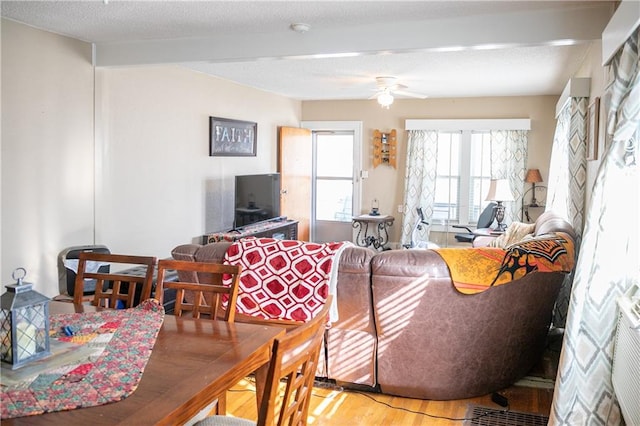 living room featuring a textured ceiling, hardwood / wood-style flooring, and ceiling fan