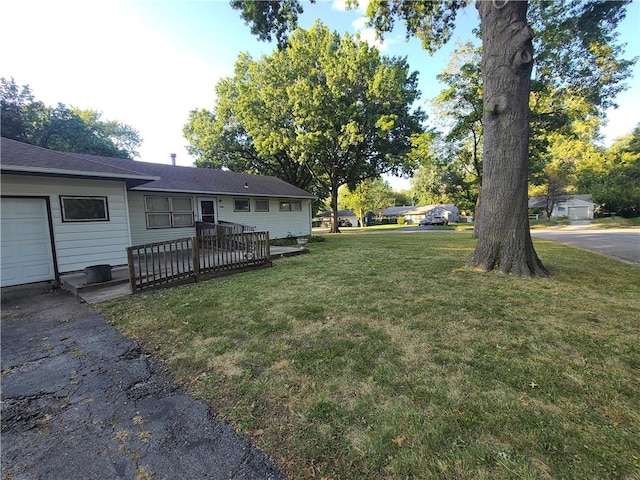 view of yard with a wooden deck and a garage