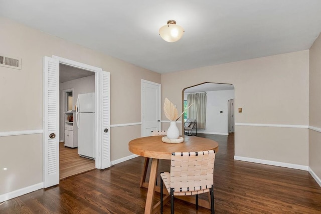 dining area featuring dark wood-type flooring