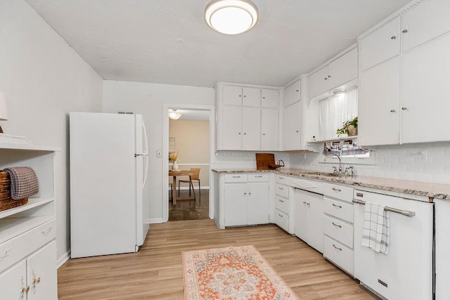 kitchen featuring light hardwood / wood-style flooring, white appliances, and white cabinetry