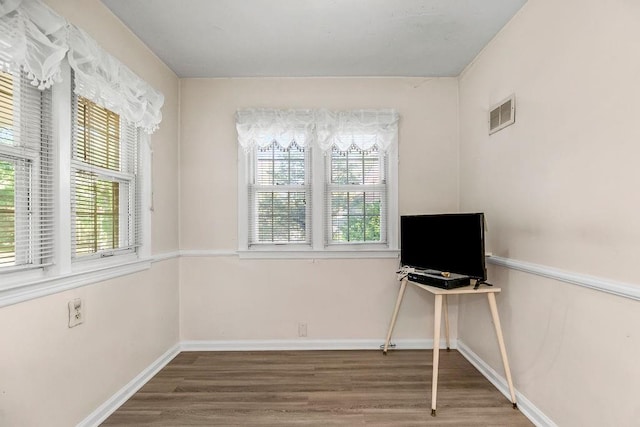 unfurnished office featuring hardwood / wood-style floors