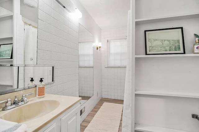 bathroom with vanity, tile walls, hardwood / wood-style floors, and a shower with shower curtain