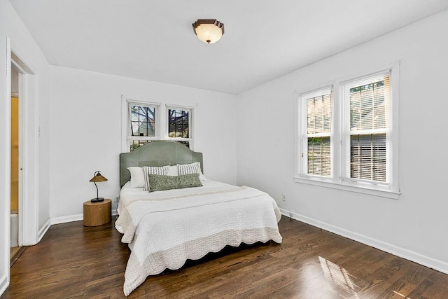 bedroom with dark hardwood / wood-style floors