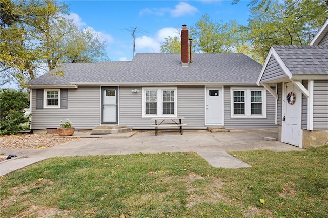 back of house with a yard and a patio