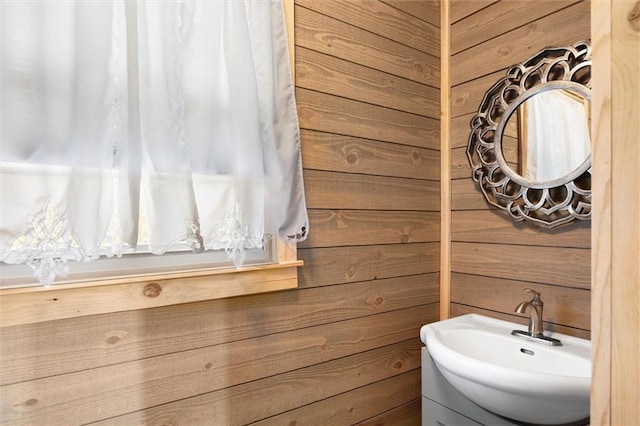 bathroom with vanity and wooden walls