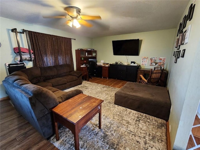 living room featuring dark hardwood / wood-style flooring and ceiling fan