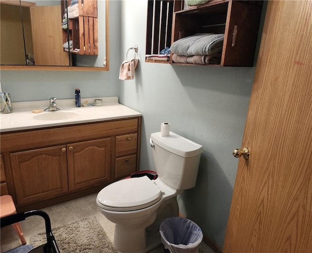 bathroom featuring tile patterned flooring, vanity, and toilet