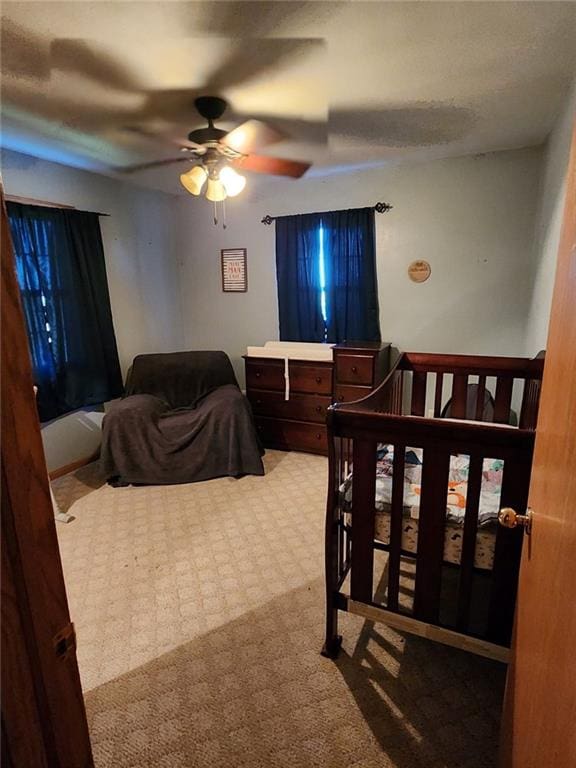 bedroom with ceiling fan and carpet floors