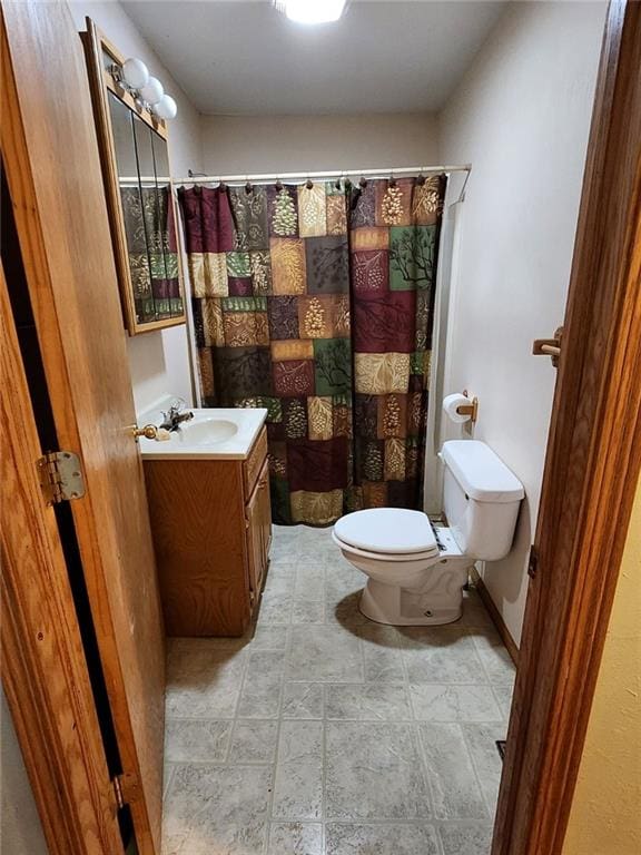 bathroom featuring vanity, toilet, and a shower with curtain