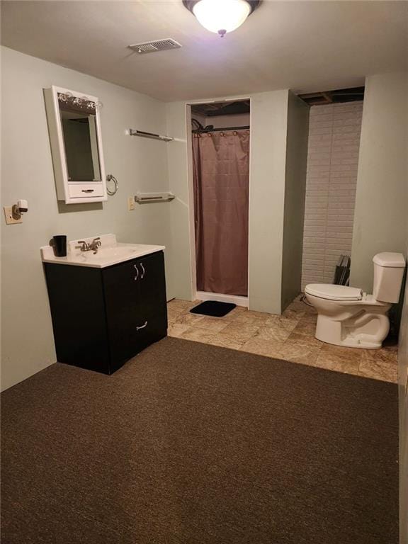 bathroom featuring vanity, toilet, and a shower with curtain