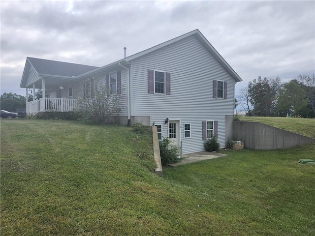 view of side of home with a yard