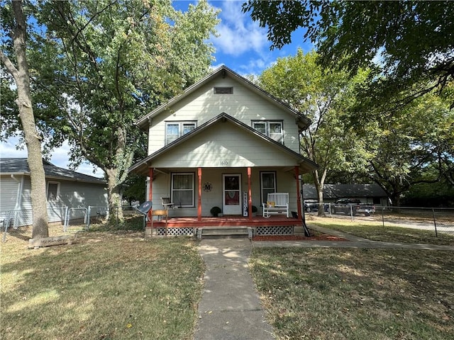 bungalow-style home featuring a front yard and a porch