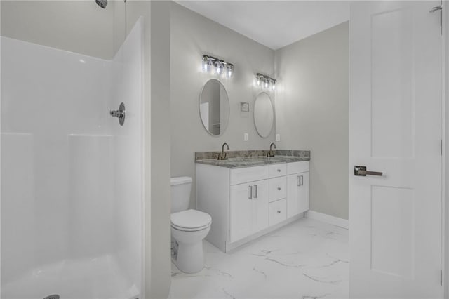 bathroom featuring walk in shower, vanity, and toilet