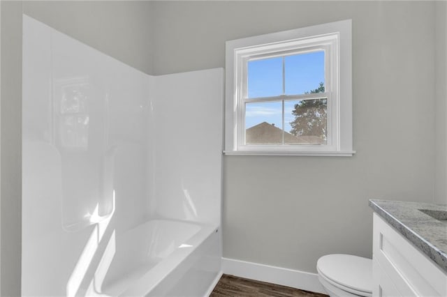 full bathroom featuring wood-type flooring, vanity, toilet, and bathtub / shower combination