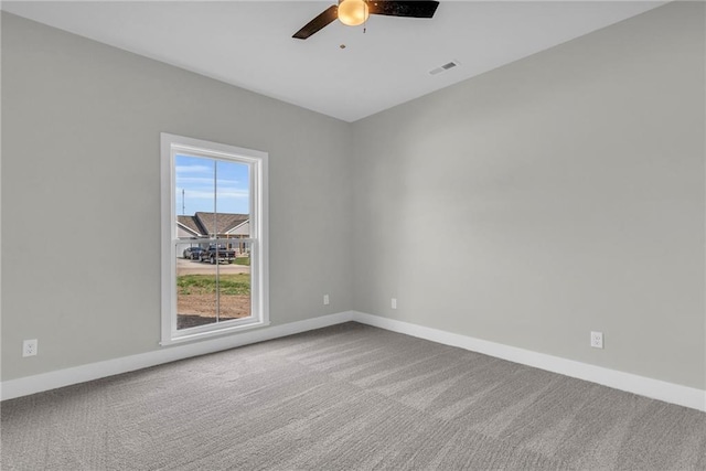 spare room with carpet floors and ceiling fan