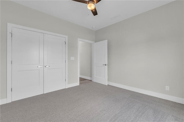 unfurnished bedroom with carpet flooring, ceiling fan, and a closet