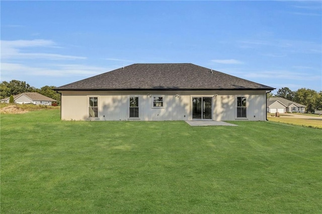 rear view of house with a patio area and a yard