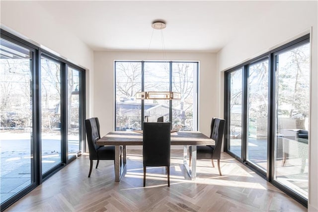 dining area with parquet flooring