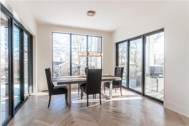 dining space with parquet flooring