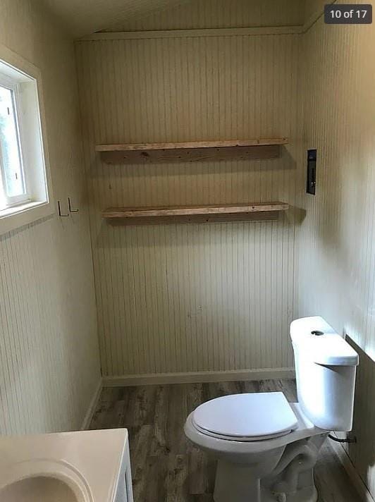 bathroom with vanity, toilet, and hardwood / wood-style floors