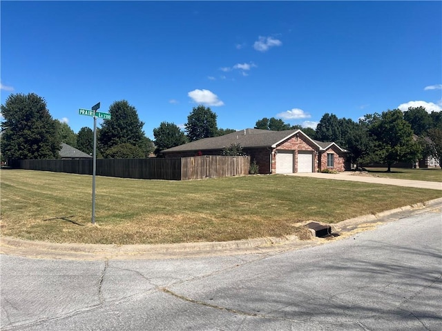 view of front of house featuring a garage and a front lawn