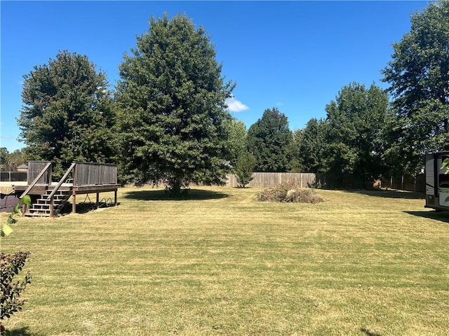 view of yard with a deck and fence