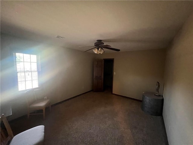 spare room featuring baseboards, ceiling fan, and visible vents