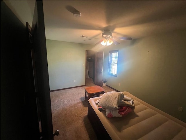 carpeted bedroom with baseboards, visible vents, and a ceiling fan