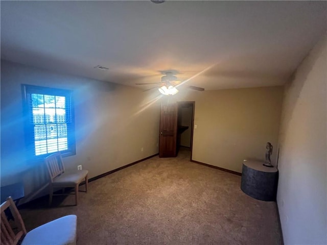 unfurnished room with carpet floors, baseboards, and ceiling fan