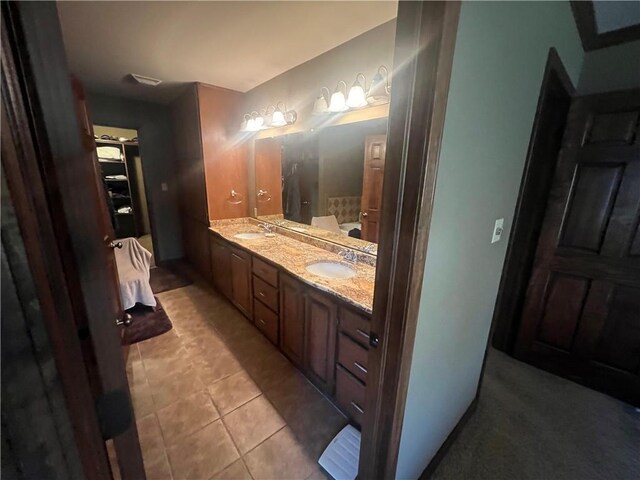 full bathroom with tile patterned flooring, a sink, and double vanity