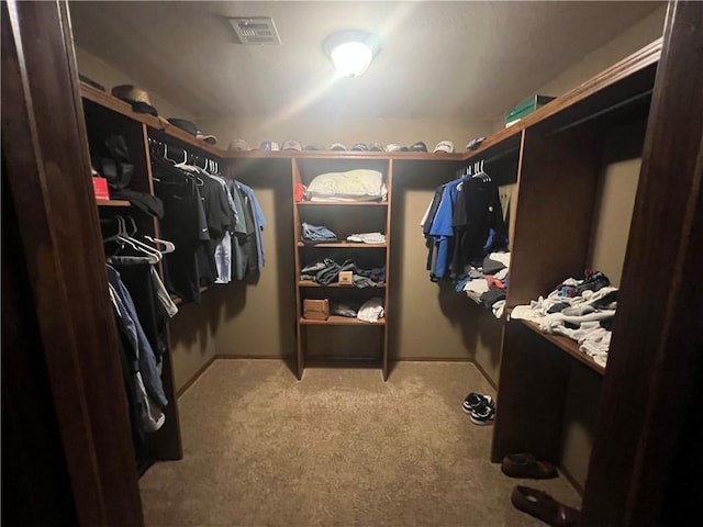spacious closet featuring visible vents and light carpet