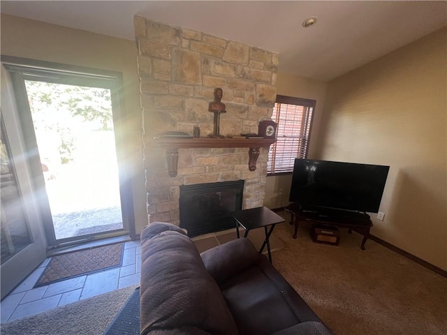 living room with carpet flooring and a stone fireplace