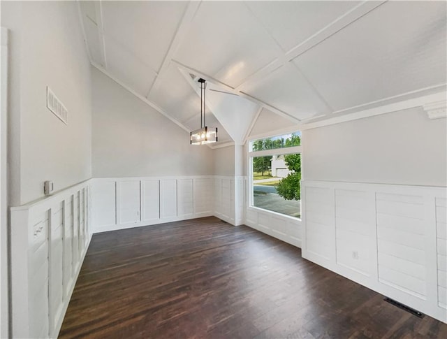 interior space with vaulted ceiling, an inviting chandelier, and dark hardwood / wood-style flooring