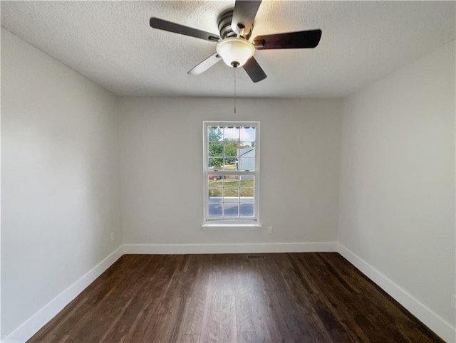 empty room featuring a textured ceiling, dark hardwood / wood-style flooring, and ceiling fan