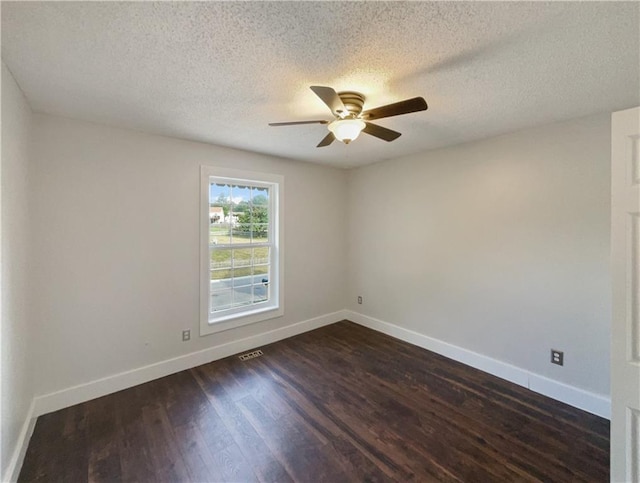 spare room with ceiling fan, dark hardwood / wood-style floors, and a textured ceiling