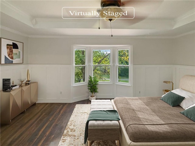 bedroom featuring a tray ceiling, dark wood-type flooring, and crown molding