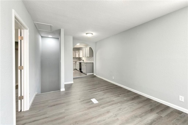 empty room featuring a textured ceiling and hardwood / wood-style floors