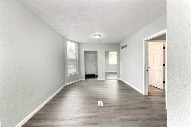 entrance foyer featuring a textured ceiling and dark hardwood / wood-style floors