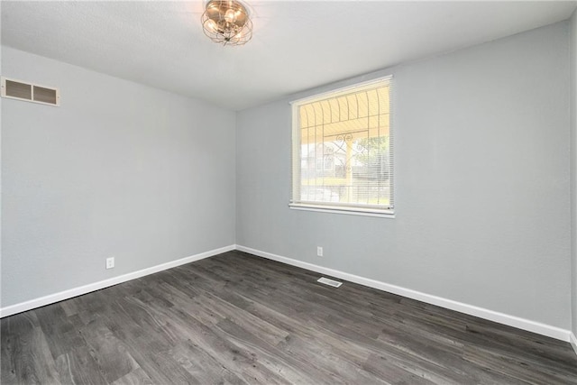 spare room featuring dark hardwood / wood-style flooring