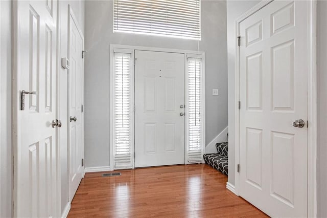 foyer entrance with light hardwood / wood-style flooring