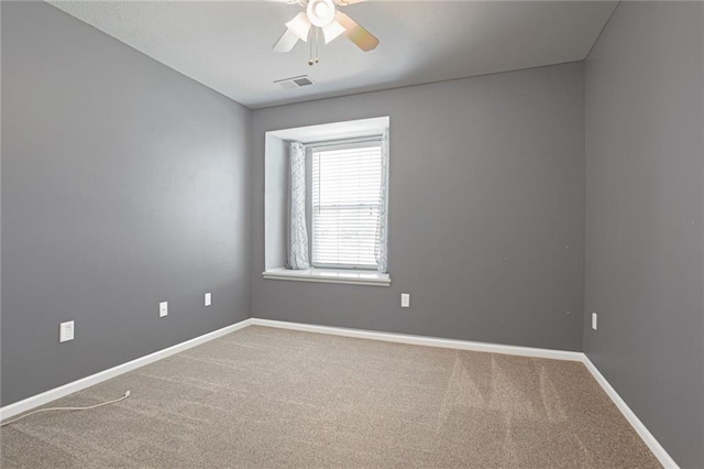 carpeted spare room with ceiling fan