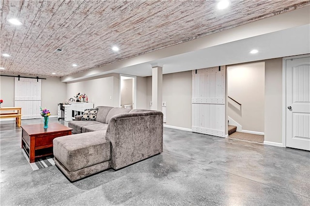 living room with a barn door, baseboards, stairway, concrete floors, and recessed lighting