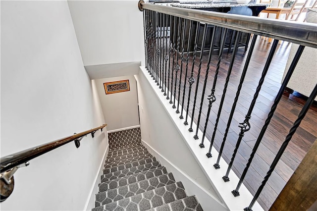 stairway featuring baseboards and wood finished floors