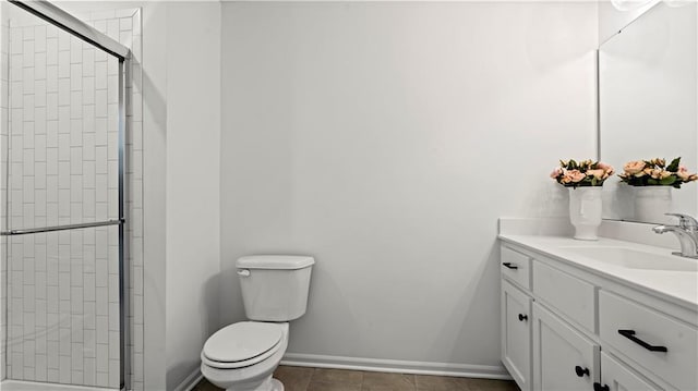 full bathroom featuring toilet, a shower stall, baseboards, and vanity