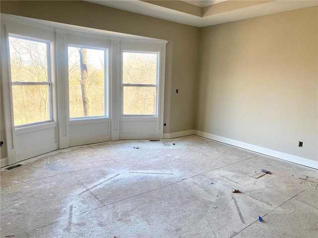 empty room featuring baseboards and visible vents