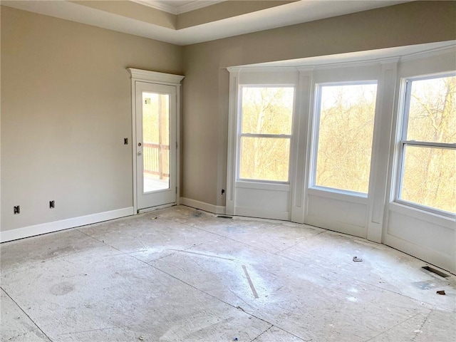 unfurnished room with baseboards and ornamental molding