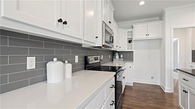 kitchen featuring appliances with stainless steel finishes, white cabinets, ornamental molding, and backsplash