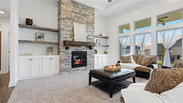 living area featuring a high ceiling and a fireplace