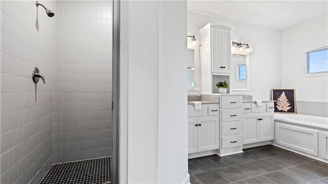 bathroom with a garden tub, a shower stall, tile patterned floors, and vanity