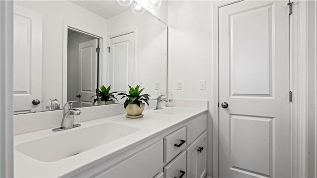 full bathroom with a sink and double vanity